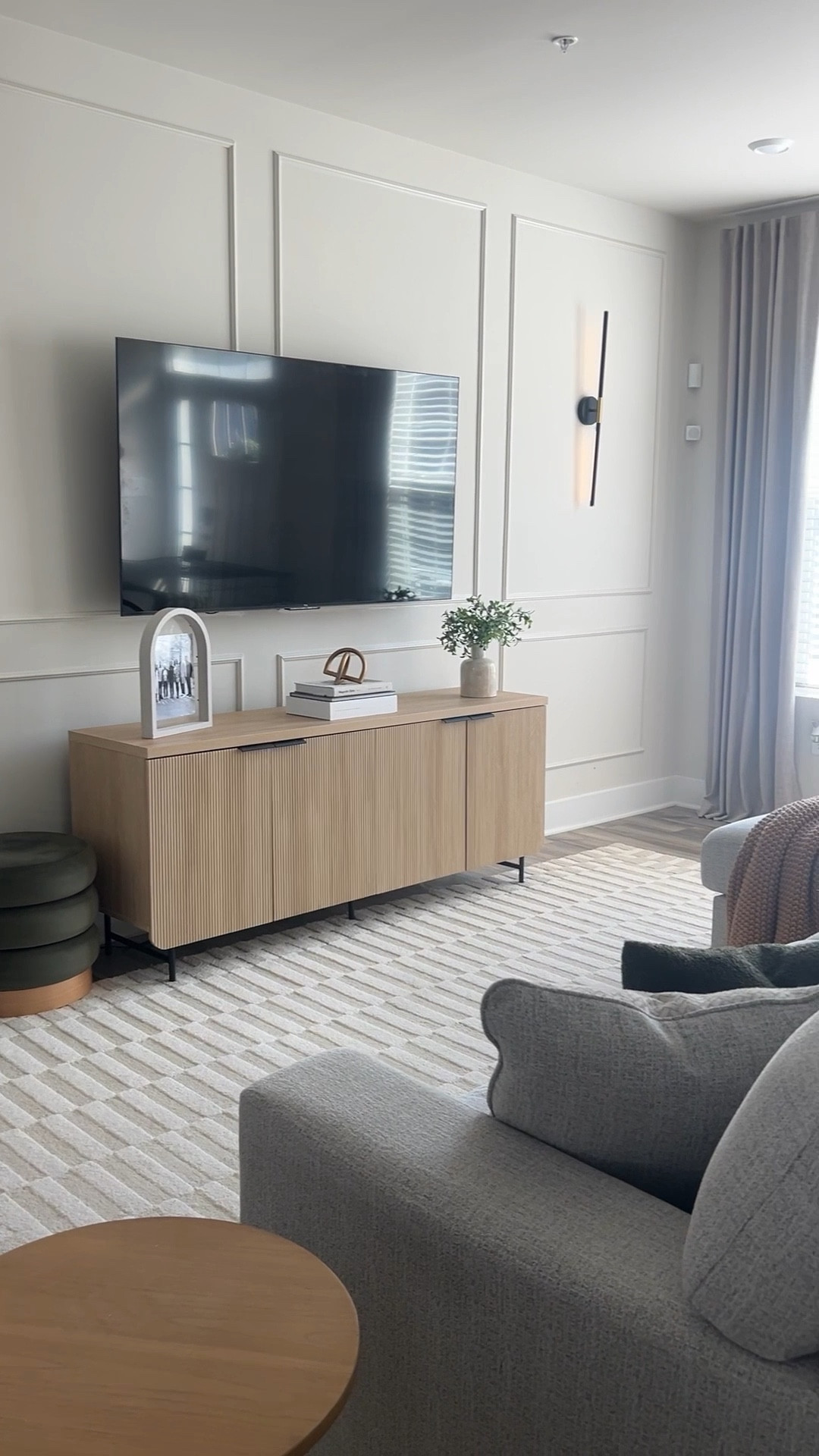 Builder-grade living room before and after 🤩 Adding the wall molding was the best decision and it was super simple, just peel and stick! 

#LTKHome #LTKFindsUnder100