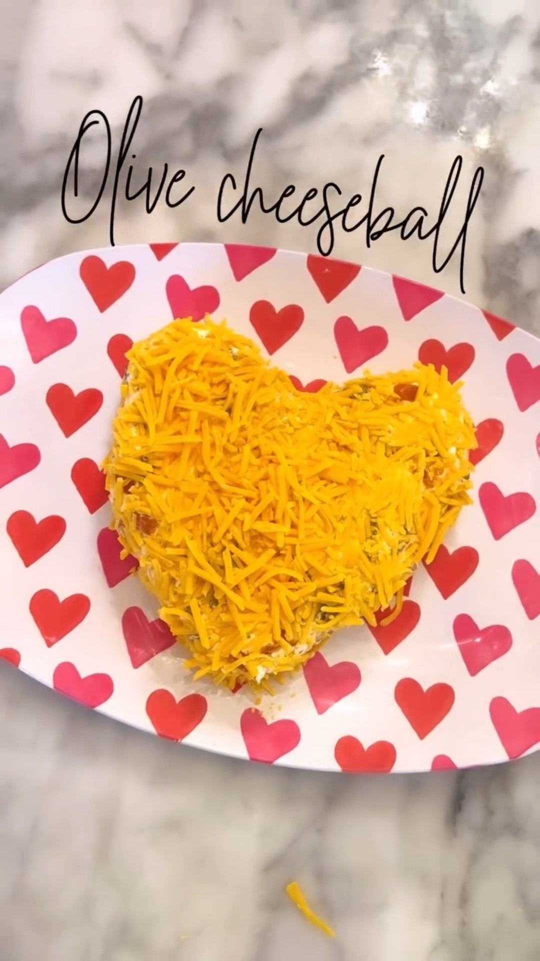 Olive cheeseball 
2 blocks of softened cream cheese 
1 cup of diced green olives 
2 cups of shredded cheddar 
(Set 1 cup aside for topping) 
1 package of Hidden Valley Ranch seasoning 

Mix it all together well. Place in the refrigerator for 30-60 minutes.  Shape into a heart and top with last cup of shredded cheddar. Serve with crackers or veggies 

#LTKfoodie #LTKmomlife #LTKSeasonal