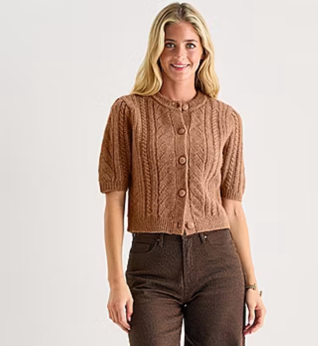 This a.n.a women's short-sleeve cardigan from JCPenney is a warm cozy layer that's the perfect transitional style to wear when there's a chill. It features a chic, warm cable-knit pattern with ribbed trims, puff sleeves and button-fron closures. Wear it with jeans and ankle boots.

#LTKSaleAlert #LTKStyleTip