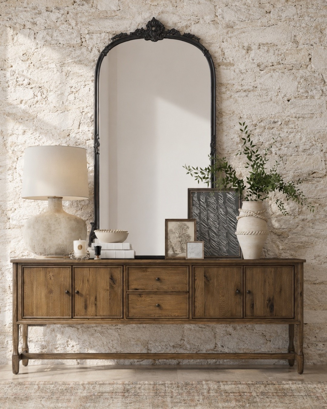 This is your sign to treat the entryway like a real design moment. A warm wood console, oversized black arched mirror, textured stone wall, ceramic lamp, vintage-inspired art, and greenery create that collected designer look that feels layered but not cluttered. Such an easy formula for an entry table, hallway console, or living room storage piece.
I may receive a commission when you shop through my links.

#LTKHome