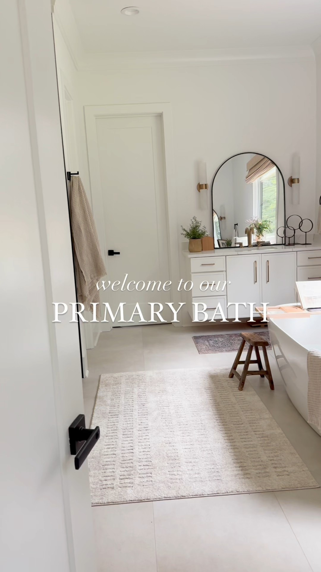 Welcome to our Primary Bathroom.

This space is my sanctuary. The freestanding soaking tub makes it feel like a spa retreat at home.

The walk-in shower is a total dream with three shower heads (yes, three!) and the same wood-look tile that we used around the fireplace continues here for a cohesive, cozy feel.

We went with warm gold fixtures throughout, and our big window lets in the best light.

We still haven't decided if we want to hang the mirrors or not, kind of loving that they can be hung or free standing! 

Check out this space, and we hope it inspires you to create your own spa like retreat. 

 #LTKHome