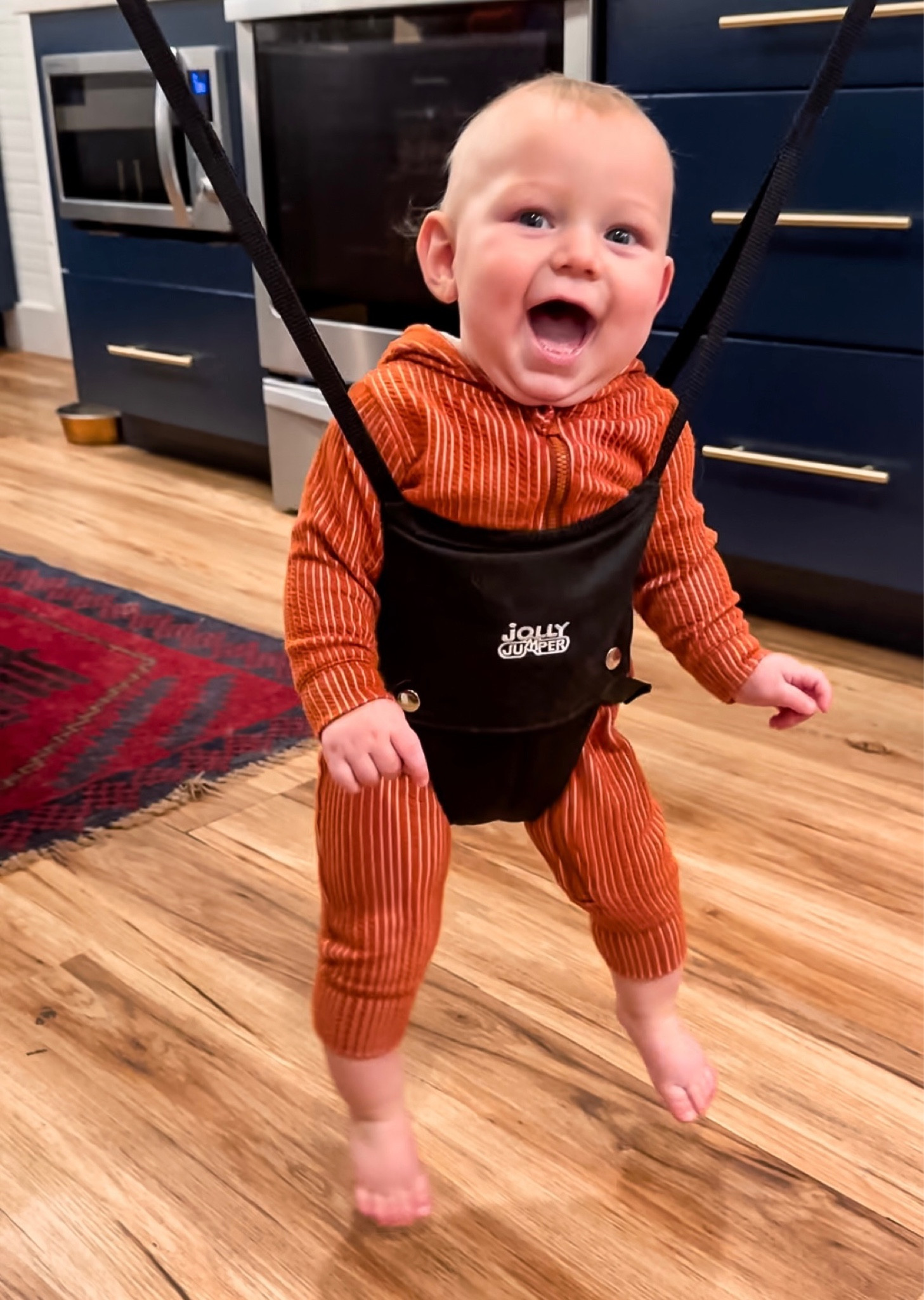 the only way mama can cook dinner with a busy 3 year old and 6 month old! we love our jolly jumper so much! it attaches to the door frame and it’s a way the baby can feel part of what’s going on without being held 💛