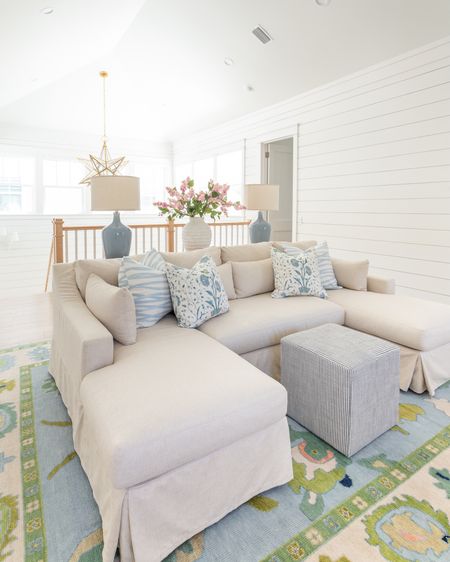 Our loft living room decorated for spring! I used these pink lilac stems, ribbed white vase, colorful oushak rug, linen sectional, light wood console table, blue lamps, striped ottoman cube, brushstroke throw pillow and floral pillow for pops of spring. See our full spring home tour here: https://lifeonvirginiastreet.com/2024-spring-home-tour/
.
#ltkhome #ltksalealert #ltkfindsunder50 #ltkfindsunder100 #ltkstyletip #ltkseasonal spring living room, sectional styling, colorful spring decor

#LTKhome #LTKSeasonal #LTKsalealert