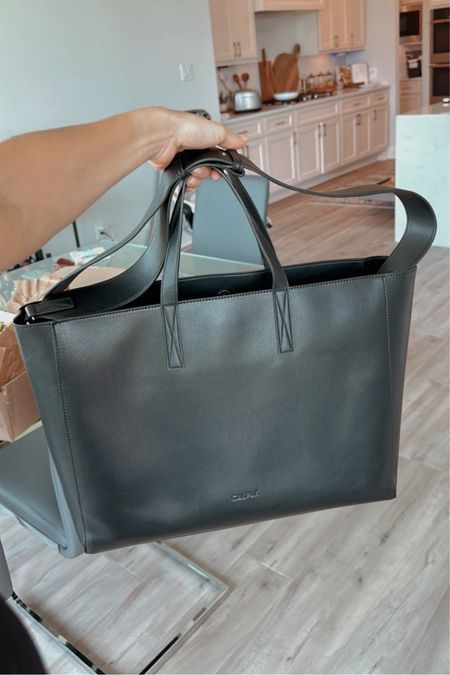 My FAVORITE work tote! So spacious, comes with a removable divider, can be held by the handles or worn on your shoulder and also has a luggage pocket. 