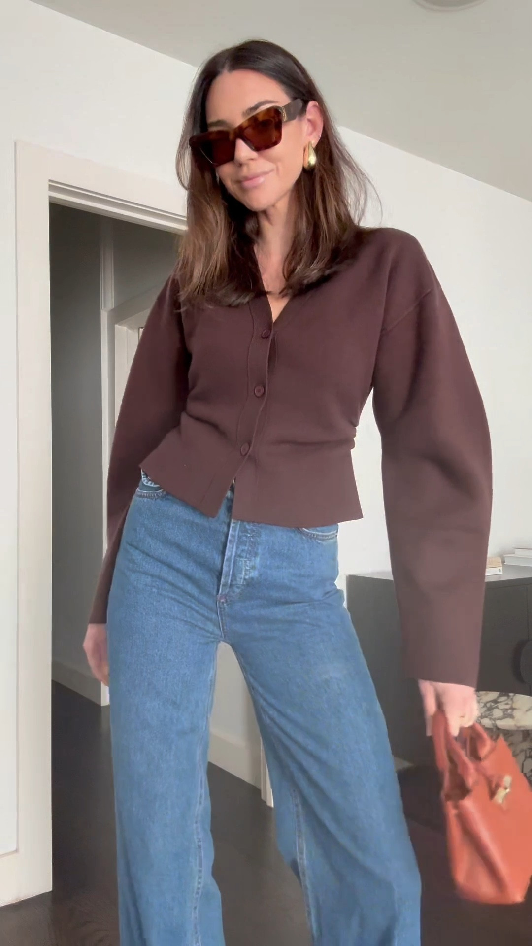 Plum cardigan 
High waisted denim
Flared jeans in indigo 
Loewe cat eye sunglasses 
White patent heels with a pointed toe 
Gold earrings 

#LTKstyletip #LTKaustralia