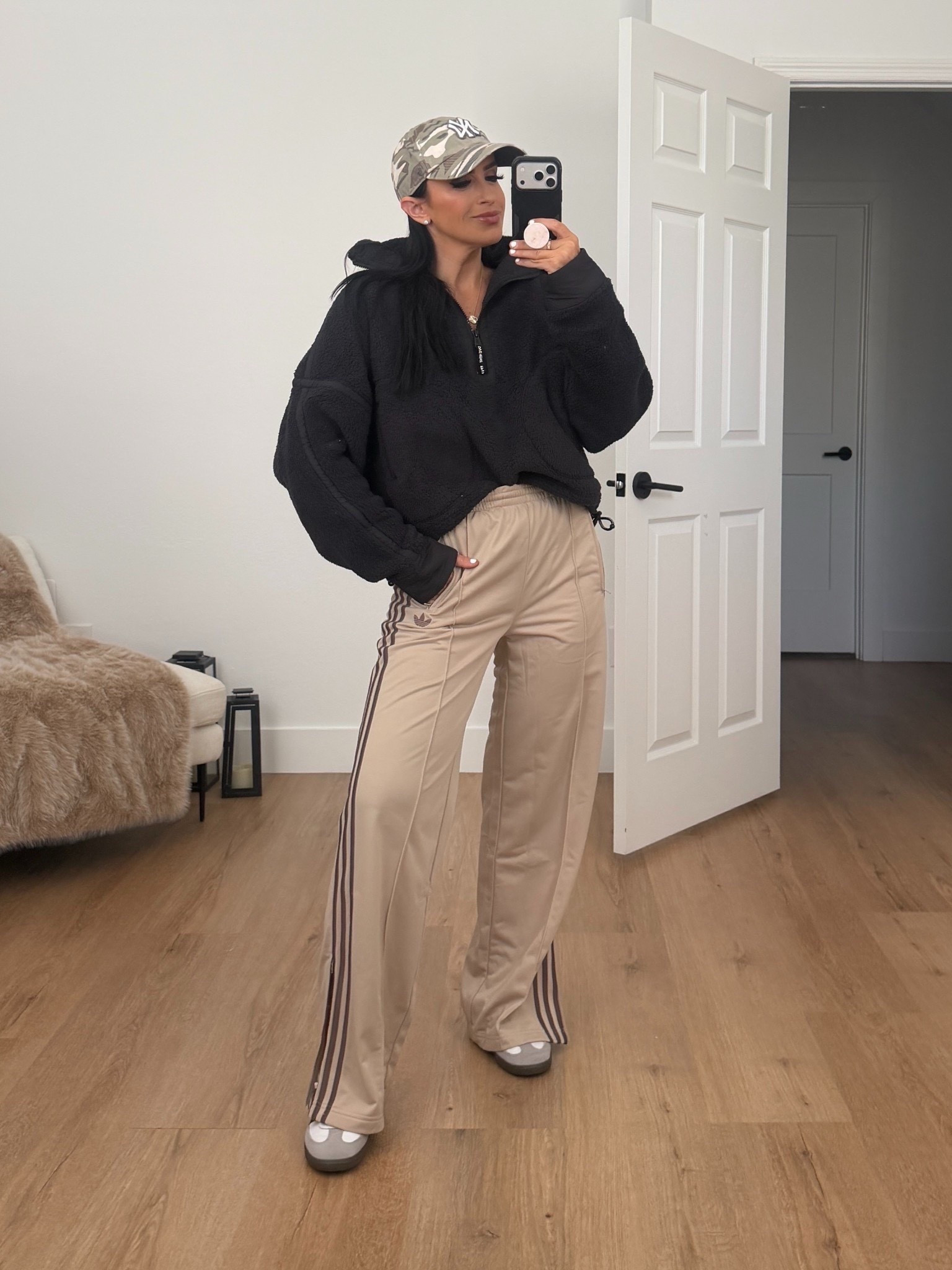 Adidas firebird loose track pants in the color stone khaki / earth strata wearing size small. Free people Mountain high half zip fleece in black wearing size small 