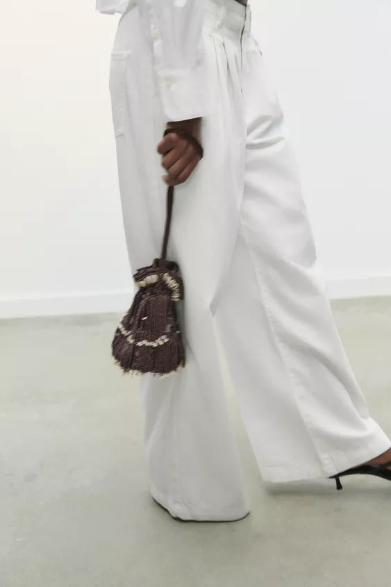 Mini bucket bag with glitter exterior, fringe, and shells. Lined interior. Double shoulder straps... | Zara US