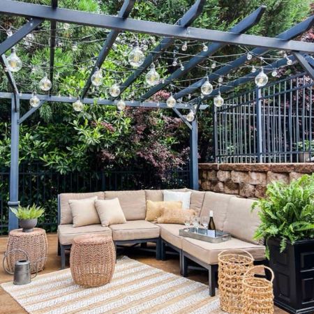Spruce up your outdoor living space for summer with a cozy seating area, neutralrug, and accent tables. Add a pergola with string lights, planters with flowers, and accent pillows to finish the refresh.

#LTKhome #LTKSeasonal #LTKstyletip