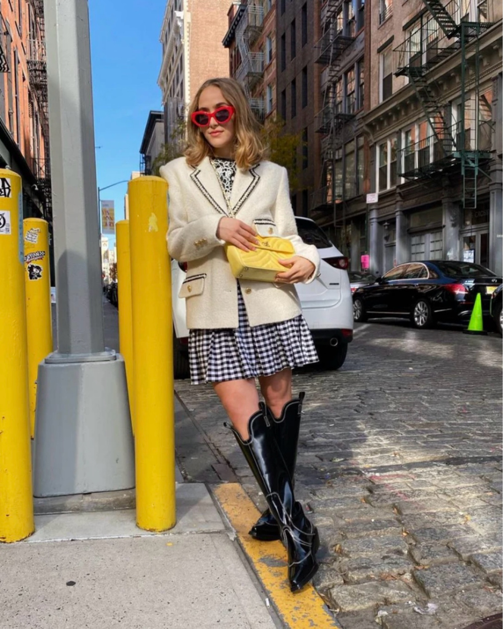 Slip into a black and white checkered dress, and layer it with a white tweed Sandro blazer adorned with gold buttons. Channel your inner diva with red cat-eye sunglasses, tall black Ganni cowboy boots, and a yellow Chanel crossbody purse. This ensemble screams confidence and class – perfect for turning heads this season.

#LTKSeasonal