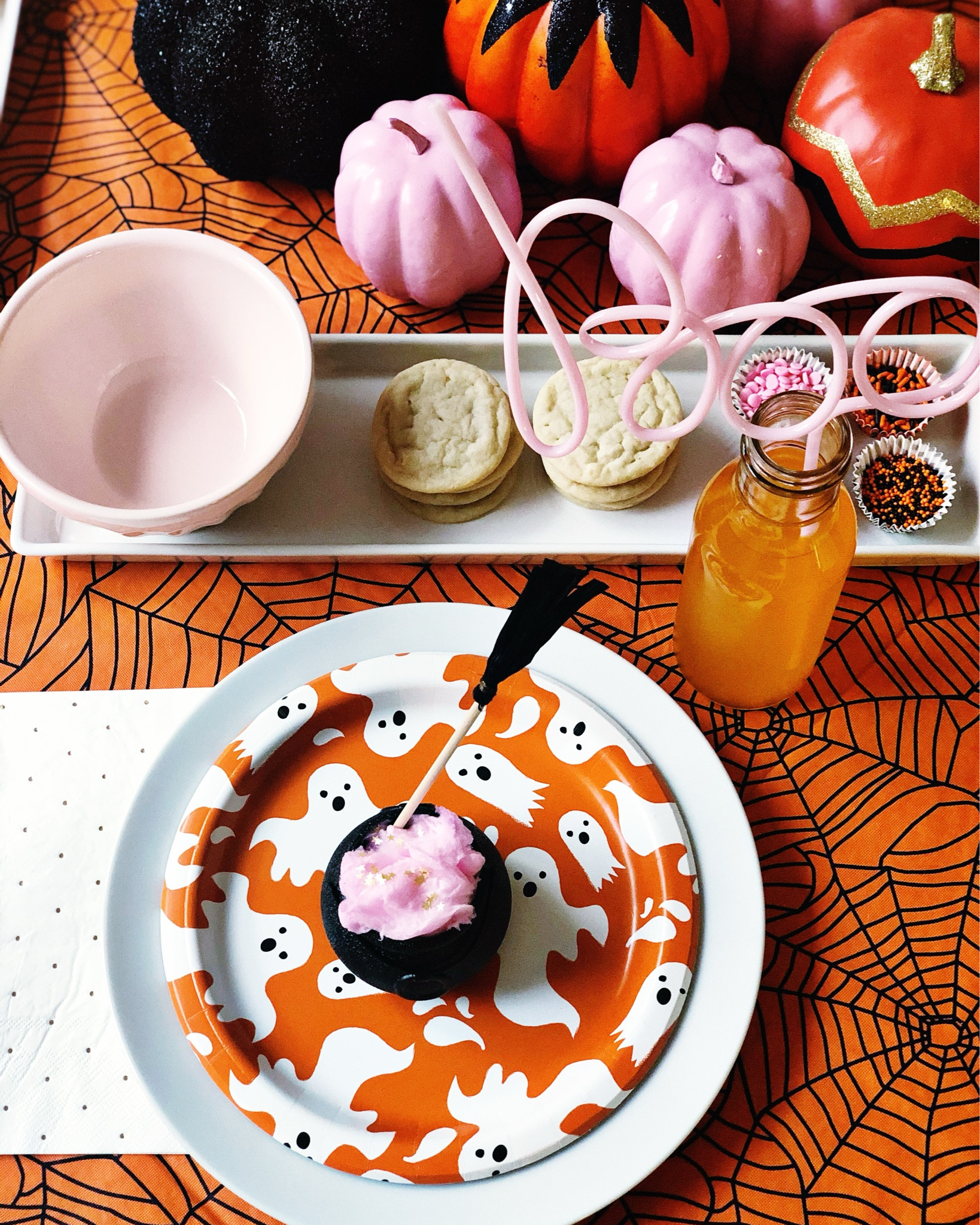 A pink, orange and black kids Halloween party. The real treat is the cotton candy sprinkled with edible glitter placed inside a cauldron. And a fun activity that included decorating Halloween cookies. Top it off with a festive drink and a boo straw you have a sweet but not spooky party… perfect for little ones.  

#LTKKids #LTKParties #LTKHalloween