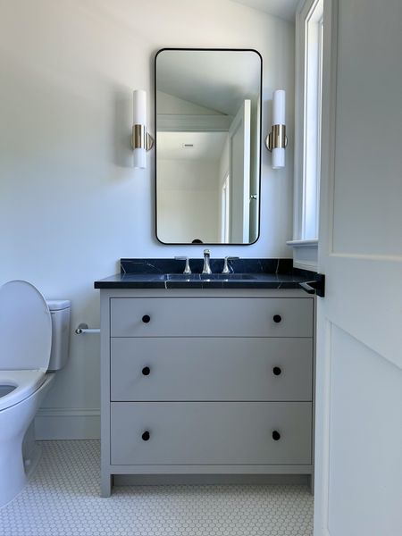 Sometimes a design calls for a neutral and flexible look.  Our Sweet and Simple Secondary Bathroom is just that!  It was designed to be a easy backdrop to work for anyone. We envision it being styled with rugs and art and bathroom accessories to bring a personal touch to a very timeless design. 
#bathroomvanity #marblecounter #mixingmetals #neutralbathroom #whitehextile