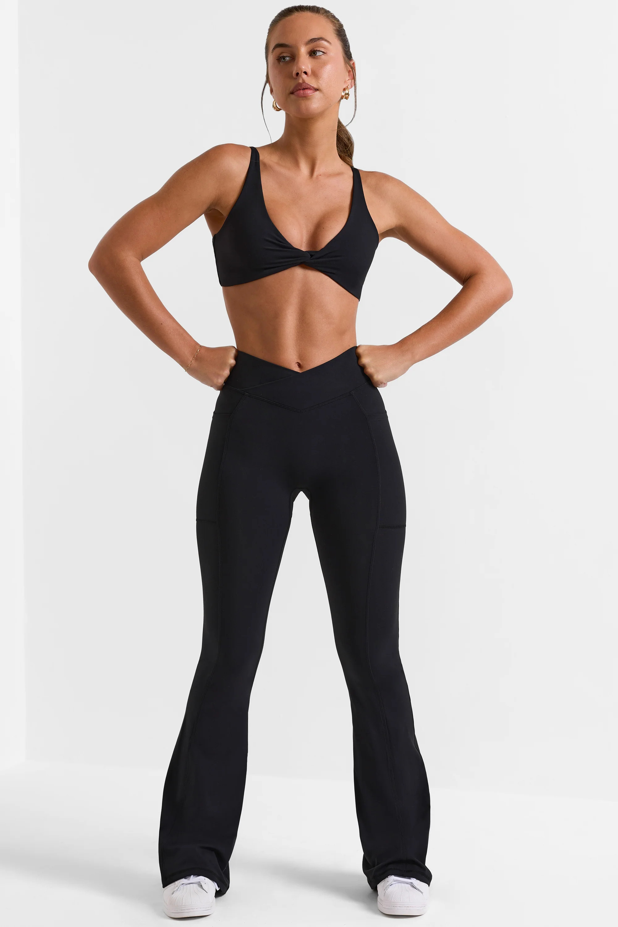 Soft Active Crossover Flared Trousers in Black | Oh Polly