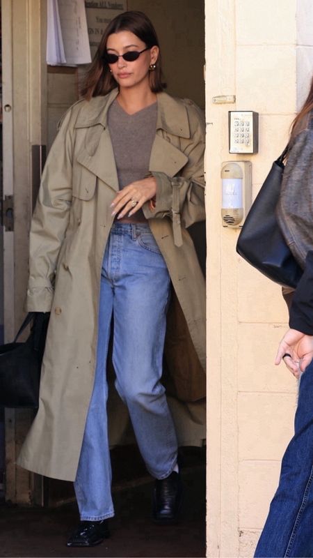 Shop Haley Bieber's cashmere V-neck sweater, sage trenchcoat jacket high waisted jeans leather tote bag small oval sunglasses leather loafers

#LTKitbag #LTKMostLoved #LTKstyletip