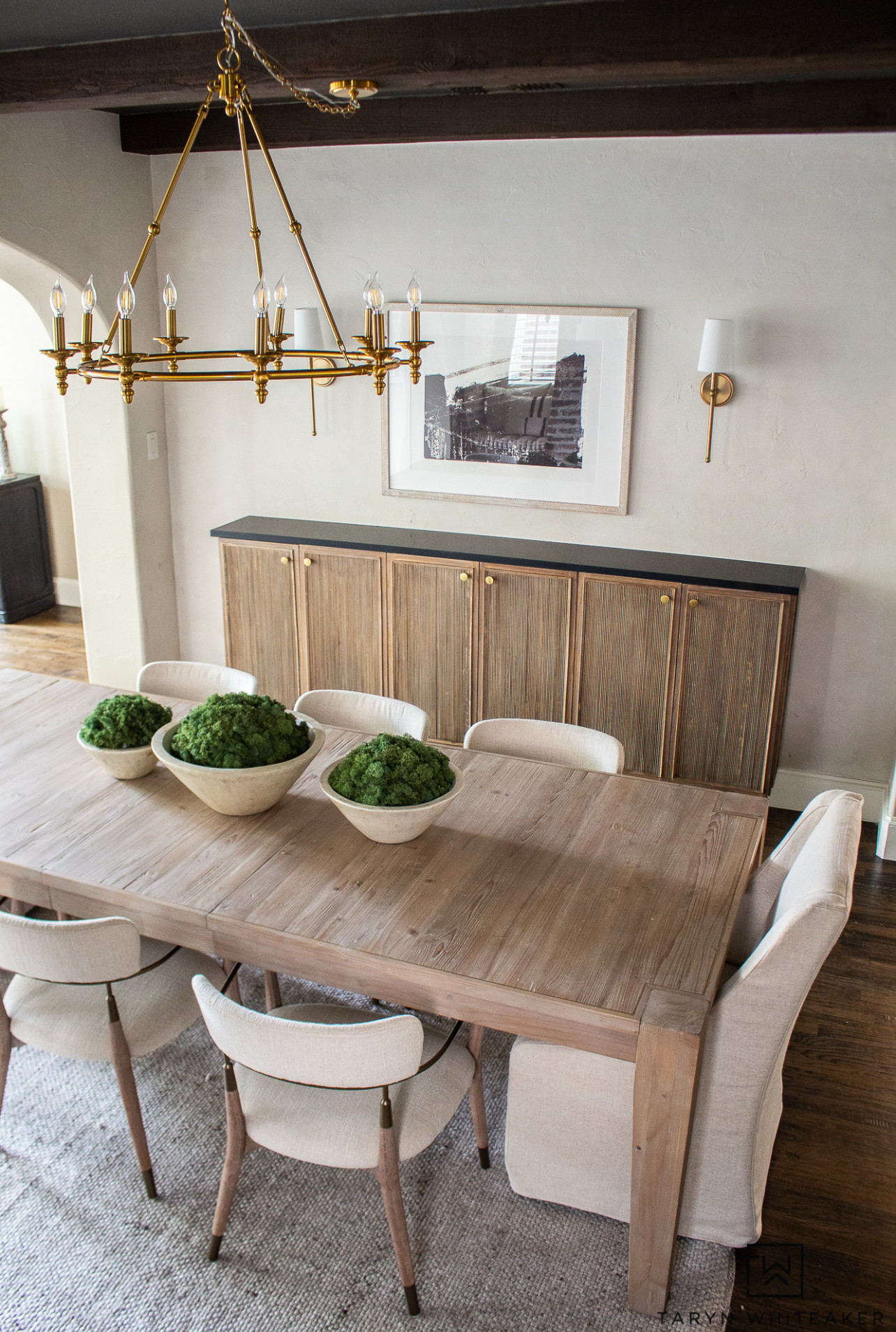 This dining room is all about warm neutrals and timeless pieces. A wood dining table, upholstered dining chairs, brass chandelier, and simple wall art make the space feel inviting and classic.

#LTKHome #LTKU #LTKSeasonal