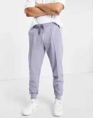 ASOS DESIGN tapered sweatpants with pin tuck in purple | ASOS (Global)
