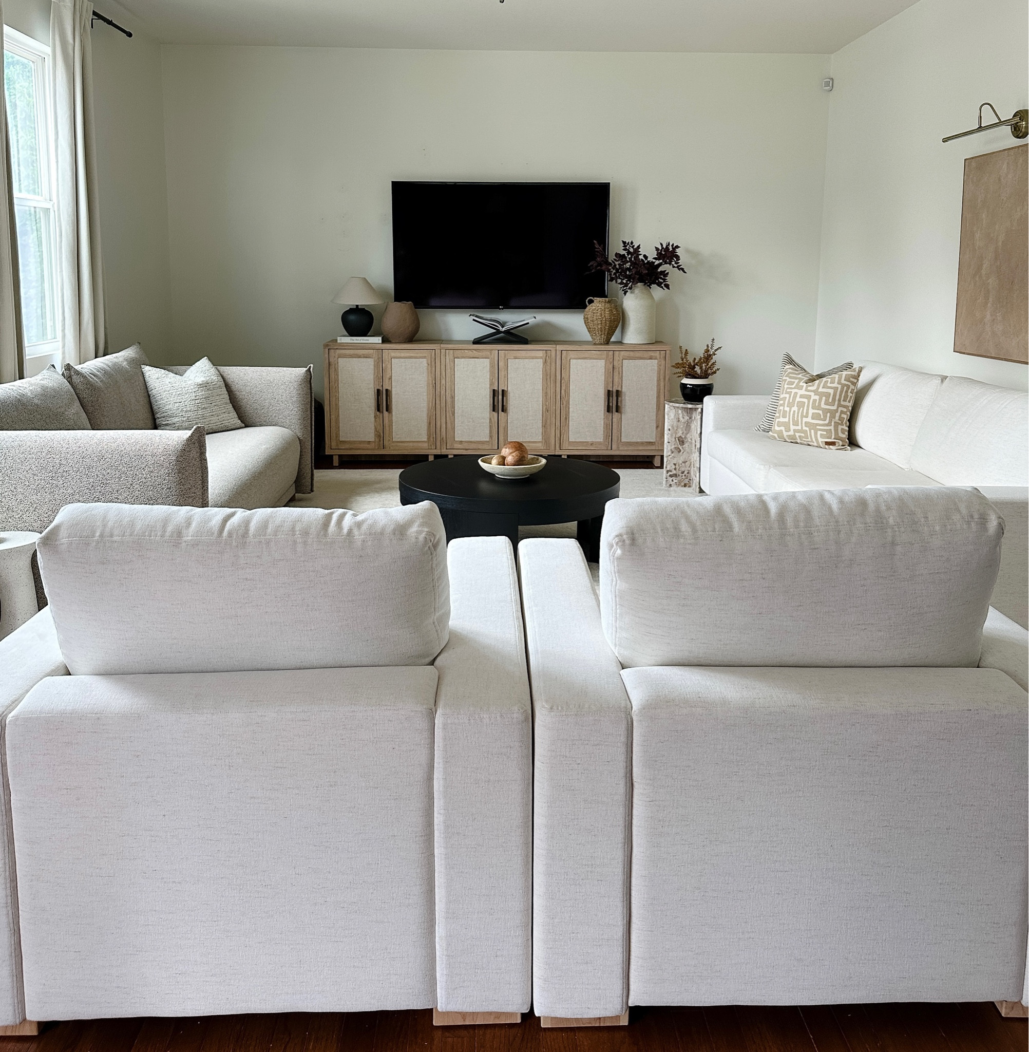 Living room sources, white furniture, white couch, wooden TV console, buffet, media cabinet, black round coffee table 

#LTKHome