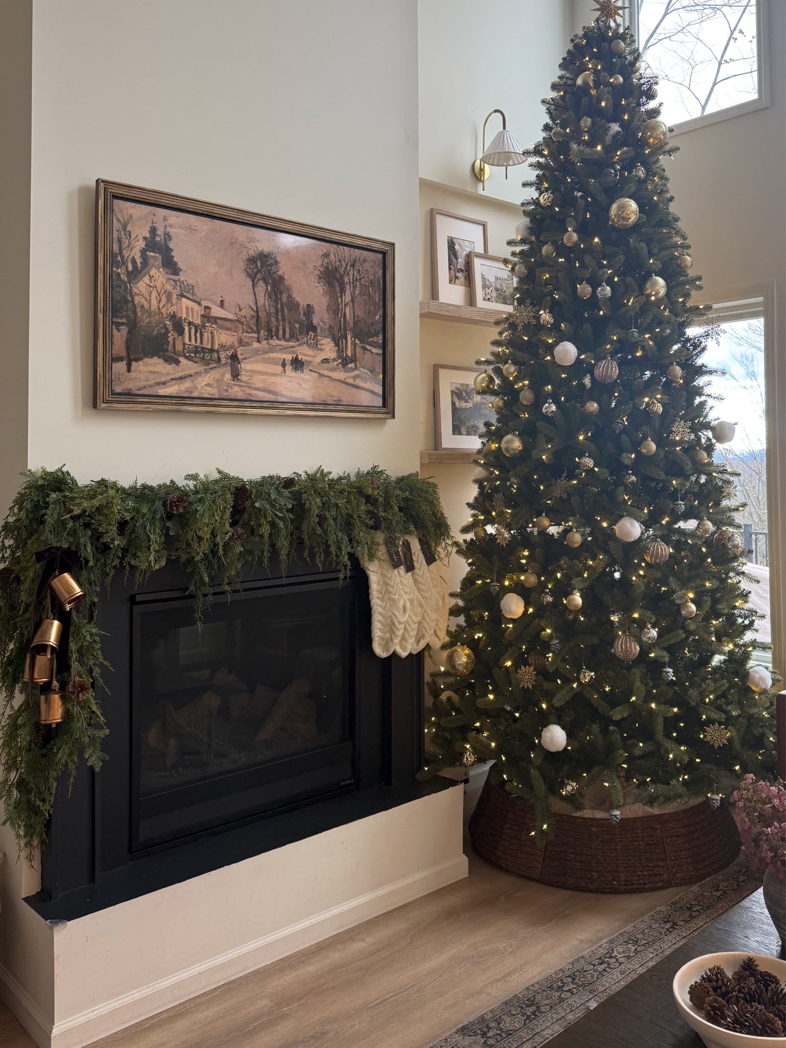 a cozy christmas corner 🤎

$11 soft touch 6ft cedar garland!! (I have 5 stacked here) 

mantle decor, mantle garland, bells, fireplace decor, tall Christmas tree, stockings, wicker tree collar, frame tv holiday, white and gold tree, neutral Christmas 

#LTKHoliday #LTKHome #LTKSeasonal