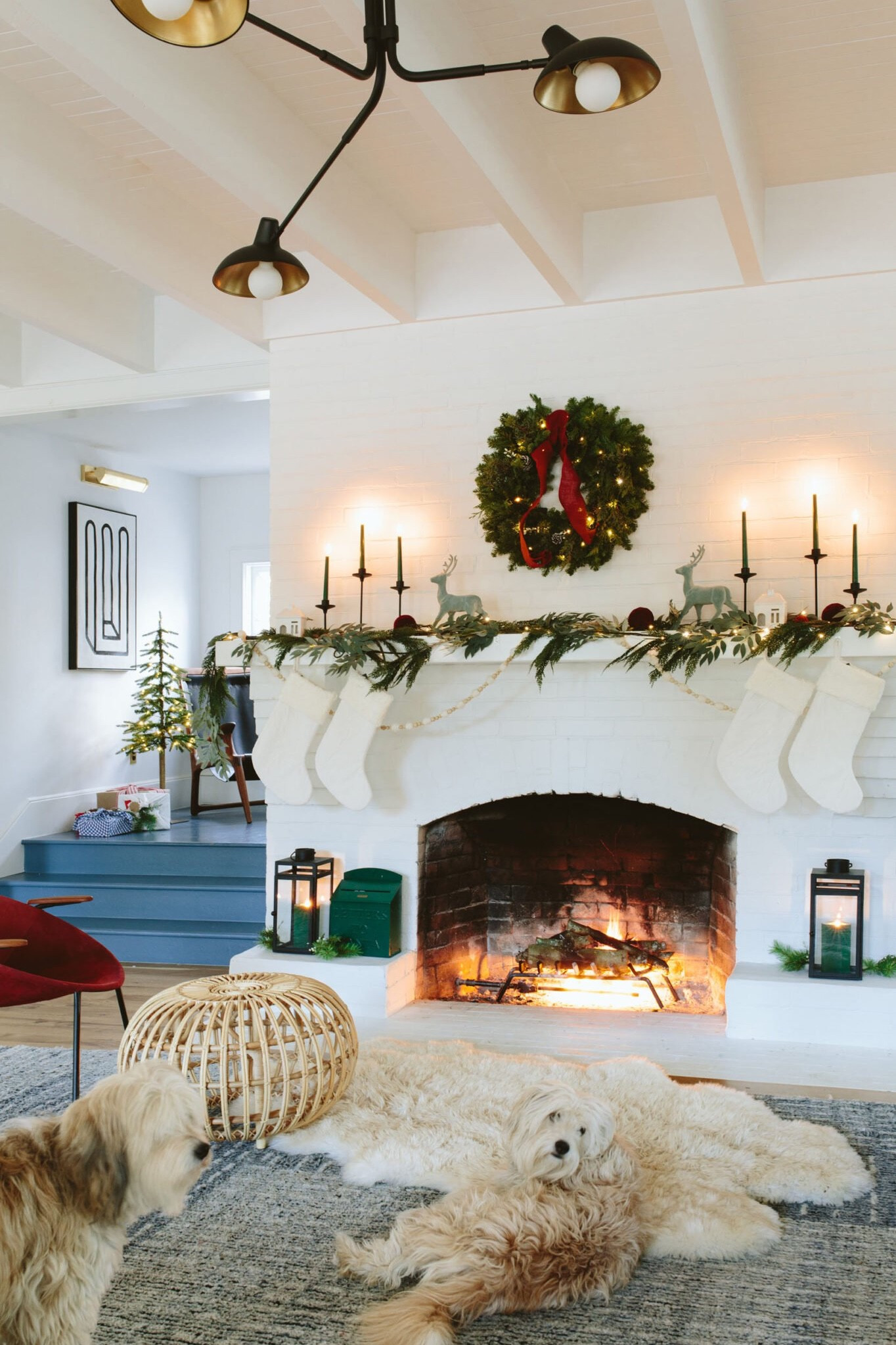 This was our easy holiday mantel from last year. The wreath was real (look at me!) and I kinda wanted to replace the garland with a real one, but not enough to actually do it. We’ve had the green Santa box for years and the kids drop letters in it frequently (I think it’s probably the last year and we totally forgot to do Elf on the Shelf which they are asking for so I need to run out and find that dude). ANYWAY - if you’re in the market for an affordable Christmas vignette, these are a few of my favorite pieces: simple wooden garland, a bit of greenery, some nice candles, a row of stockings, and a little bit of whimsy (the flocked deer come in grey this year - it’s a little more grown up than this blue version, but I love both!). 

#LTKfindsunder50 #LTKHoliday #LTKhome