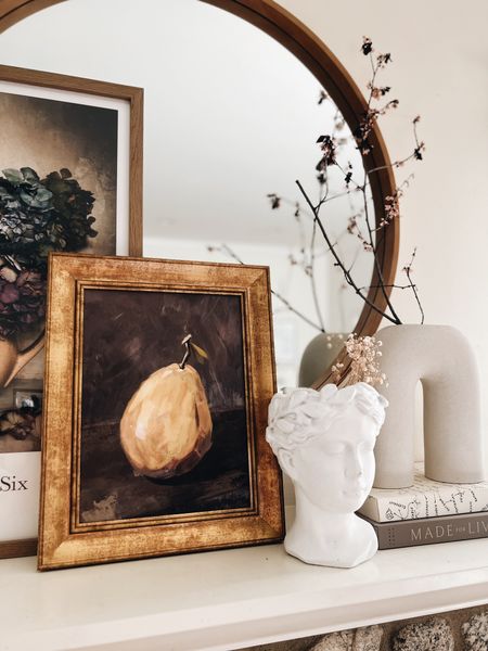 Fall fireplace decor! The large floral art is by Jamie Beck. 
-
Mantel decor - pear art - vintage art - Etsy - affordable art - Grecian bust vase - white ceramic vase - Amber Lewis Made by Design - Athena Calderone Live Beautiful - coffee table books - shelf styling - dried branches - Fall home decor - round mirror - wood mirror - Target art - Studio McGee framed art - H&M Home

#LTKhome #LTKunder100 #LTKSeasonal