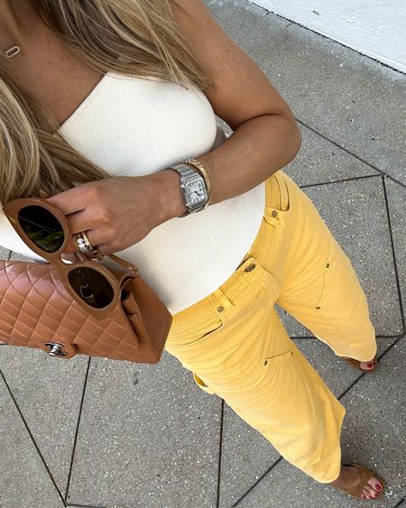 Fashion Jackson wearing ivory sweater tank (tts) yellow jeans (tts / I sized up for a relaxed fit) tan suede sandals #fashionjackson #shopbop #summeroutfits #nashvilleoutfits 

#LTKStyleTip #LTKOver40