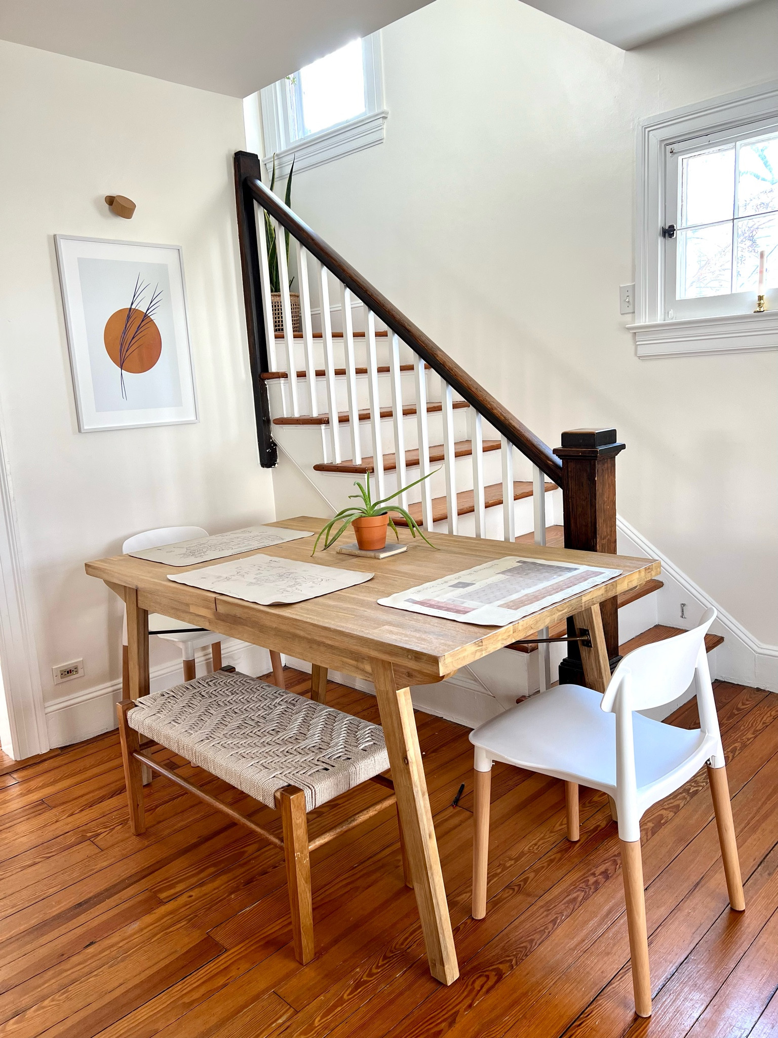 Small dining room design with lots of neutrals and natural tones: expandable dining table from Castlery (we love this table so much and it can go from seating our family of three to hosting a whole dinner party). White and natural wood tone dining chairs. Woven bench. GATHRE micros for placemats. Art from Mixtiles (keeps the wall safe!), and a little art light from Amazon. Everything is actually pulled about six inches away from the stairs, despite this angle, and we love it. How do you design for a small space? 

#LTKstyletip #LTKFind #LTKhome