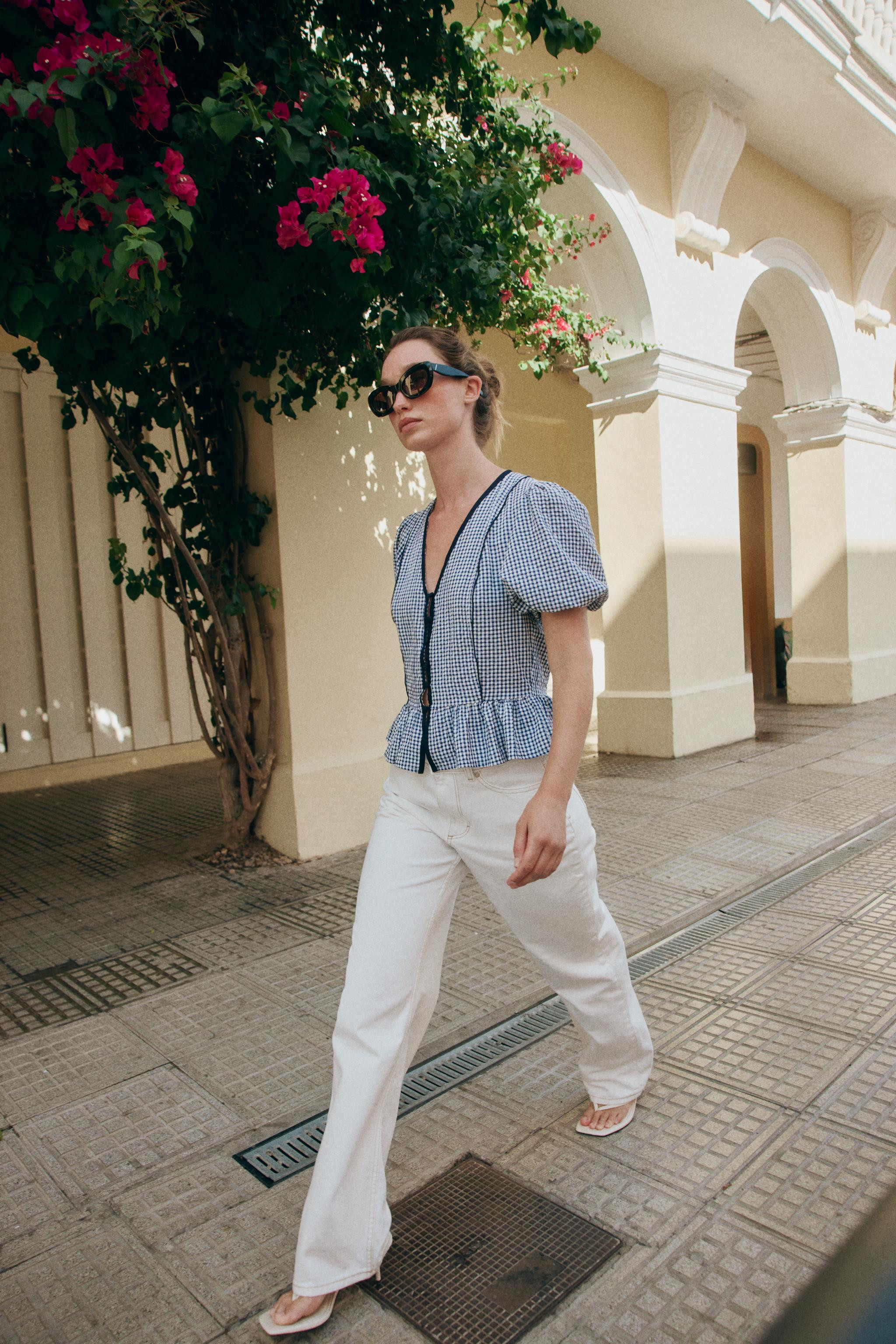 V-neck blouse with short balloon sleeves with elastic cuffs. A-line hem. Front button closure. | Zara US