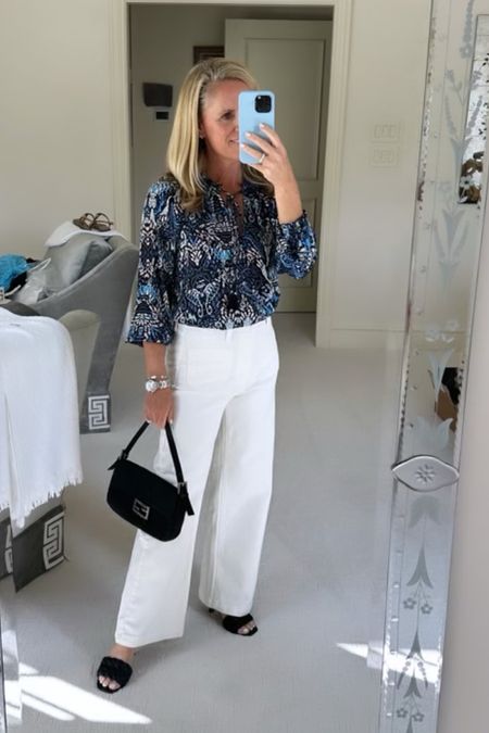 Blue and white silky top with ivory denim.   A perfect fall outfit from Avara!

Ivory denim
Blue and white top for fall
Fendi handbag
Black slide
