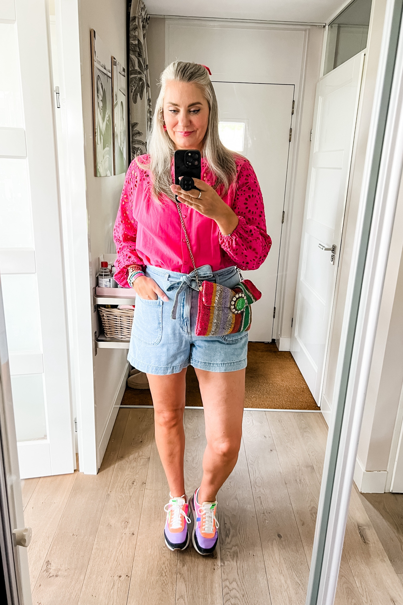 Ootd - Saturday. Fuchsia blouse with broderie sleeves (Norah, size 40), denim shorts (Mango, L), pink velvet bow clip in hair, handmade Moroccan purse, Puma sneakers. Earrings by Studio Vaia. 

#LTKnederlands #LTKeurope #LTKstyletip