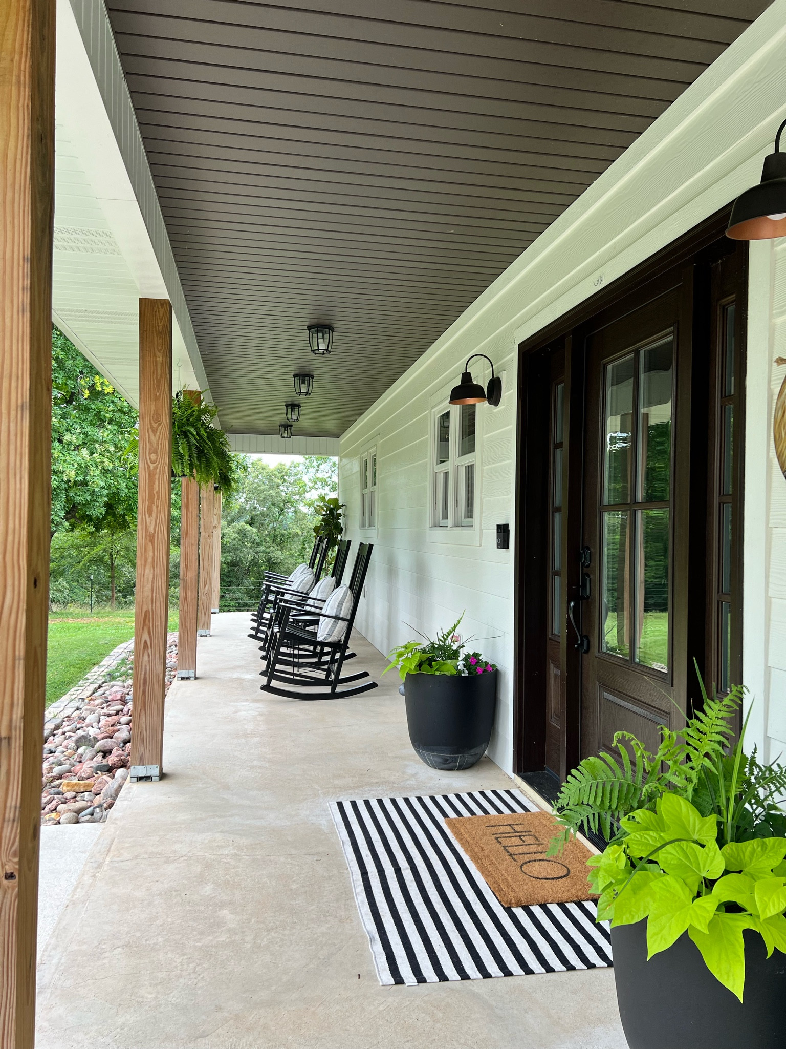 Front porch vibes!  Rocking chairs with tables and layered rugs

#LTKHome #LTKSeasonal #LTKSaleAlert