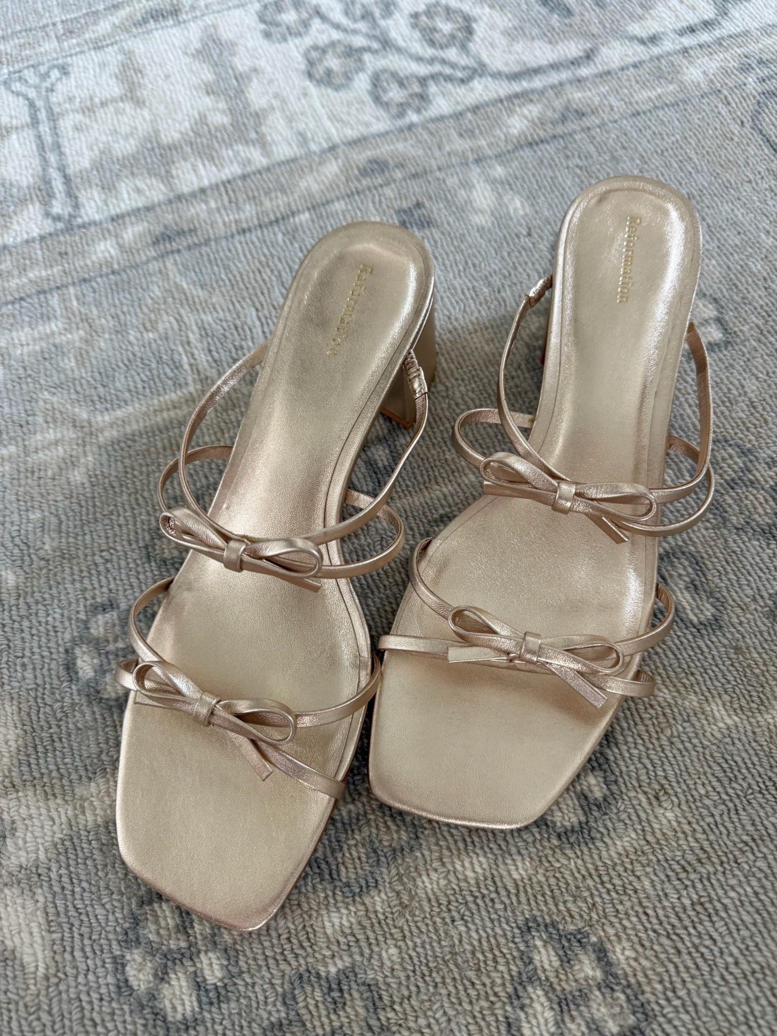 Cutest gold bow sandals for summer! They have a low blocked heel if you need a grass friendly wedding shoe. I recommend sizing up unless you have a very narrow foot  

#LTKWedding #LTKShoeCrush