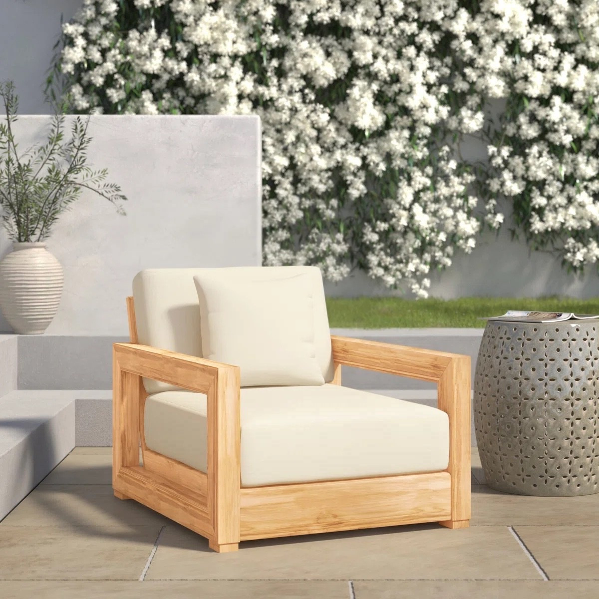 The Melrose teak outdoor lounge chair by Joss & Main is such a timeless patio piece. The solid teak wood frame paired with plush cream cushions gives it that luxury resort feel while still feeling relaxed and organic. Perfect for a modern patio, poolside setup, or layered outdoor living space with planters and a textured side table.