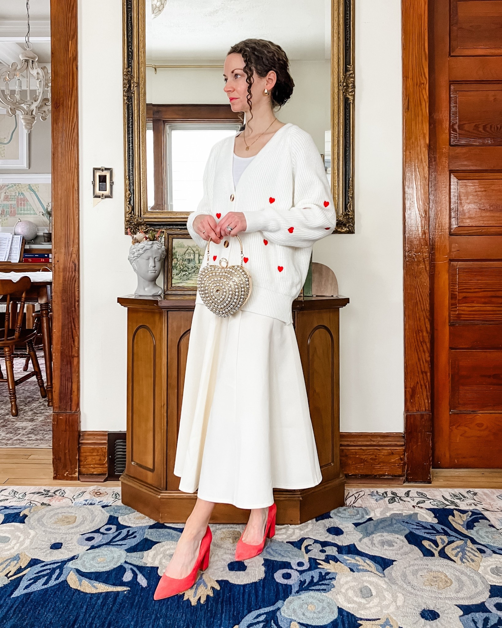 A modest Valentine’s Day outfit!
White and red embroidered heart cardigan from Chicwish. 
White cropped tank top from Amazon. 
White skirt from Chicwish. 
Jeweled heart bag from Chicwish. 
Red heels from Nine West (linking similar, mine are old). 
Gold and white topaz earrings from Peachmind. 
Gold and diamond necklace from Oak and Luna  
Petite outfit. Neutral outfit. Modest outfit. Valentine’s Day outfit   

#LTKootd #LTKValentine #LTKOver40