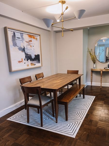 Mid century modern dining room with a Jonathan Adler Ruggable and burl wood  entry table 