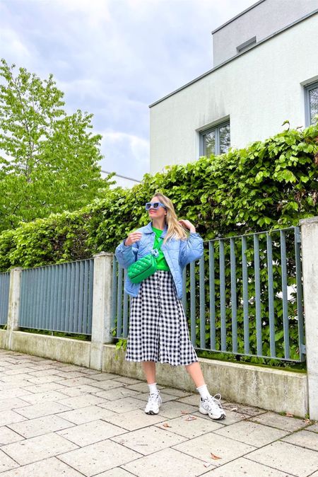 Gingham Midi Skirt. Fashion Blogger Girl by Style Blog Heartfelt Hunt. Girl with blond hair wearing a gingham midi skirt, quilted jacket, green tee, green JW Pei bag, blue oversized sunglasses, blue floral hair clip, cute socks and New Balance sneakers. #ginghamskirt #midiskirt #colorfuloutfit #colorfulstyle #colorfulfashion #colorfullooks #fashionfun #cutespringoutfit #springfashion2023 #springlookbook #fitcheck #dailylooks #dailylookbook #contentcreator #microinfluencer #discoverunder20k