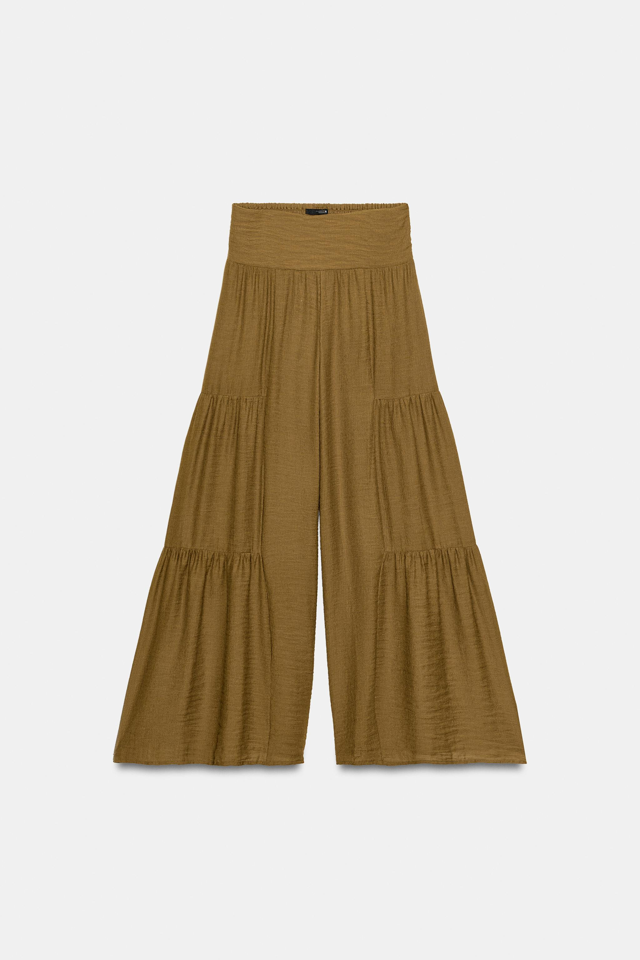 Model height: 176 cmHigh-waist trousers with an elasticated shirred back. Wide-leg design with si... | Zara UK