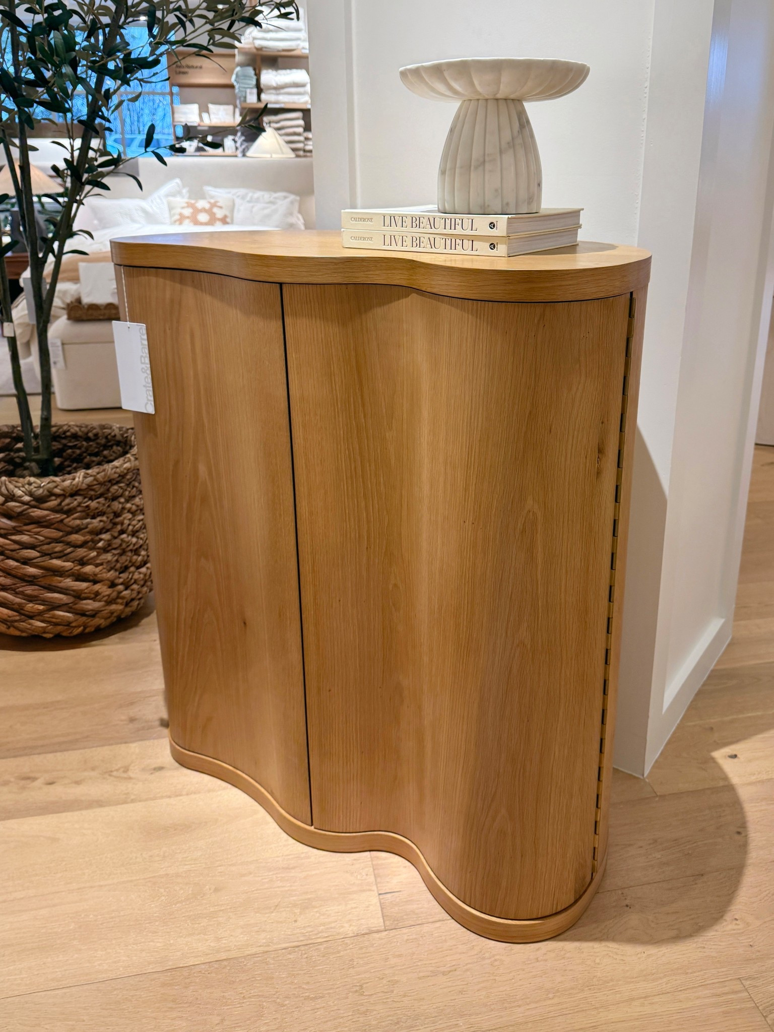 The Winslow Natural Oak Wood Bar Cabinet from Crate & Barrel features beautiful natural oak grain and a sculptural curved design that really stands out! 😍 The asymmetrical silhouette gives it a contemporary feel while still bringing warmth and texture to a space. Such a stylish piece for storing barware while adding a modern, elevated look to your living or dining area. Linked this cabinet and similar styles to shop! 🥂✨ #CrateAndBarrel #BarCabinet #ModernFurniture

#LTKHome #LTKSaleAlert