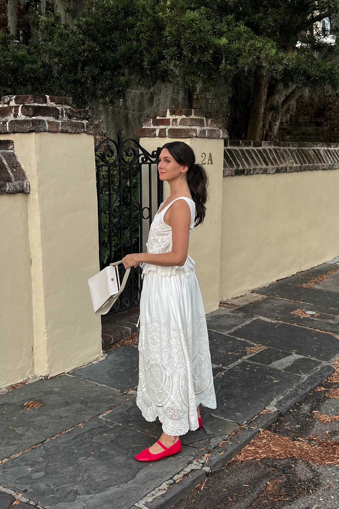 White dress, red ballet flats, dainty gold bow earrings 
