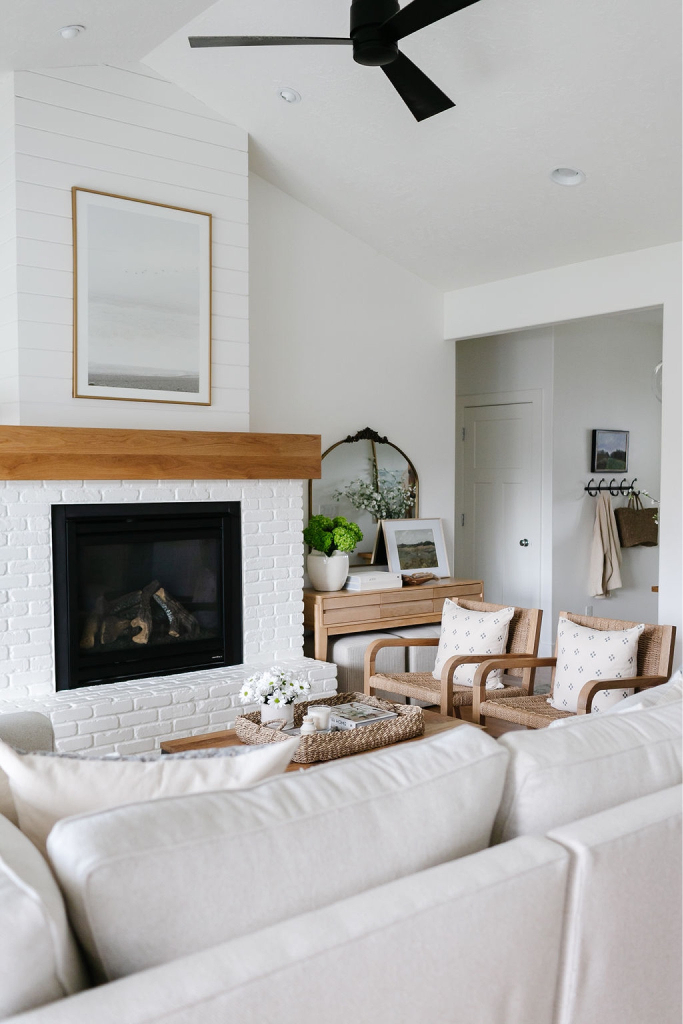 My living room with Pottery Barn Pearce sectional, beach artwork, brass mirror, Target console table, upholstered cube ottomans, woven chairs, wood and metal coffee table  

#LTKhome #LTKFind #LTKstyletip