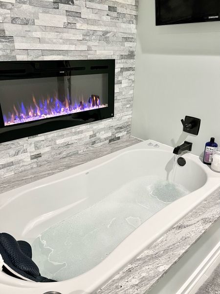 My favorite place to unwind. This bathtub is big enough to lay down completely. The pillow and fireplace make it the perfect spot!

#LTKhome #LTKbeauty