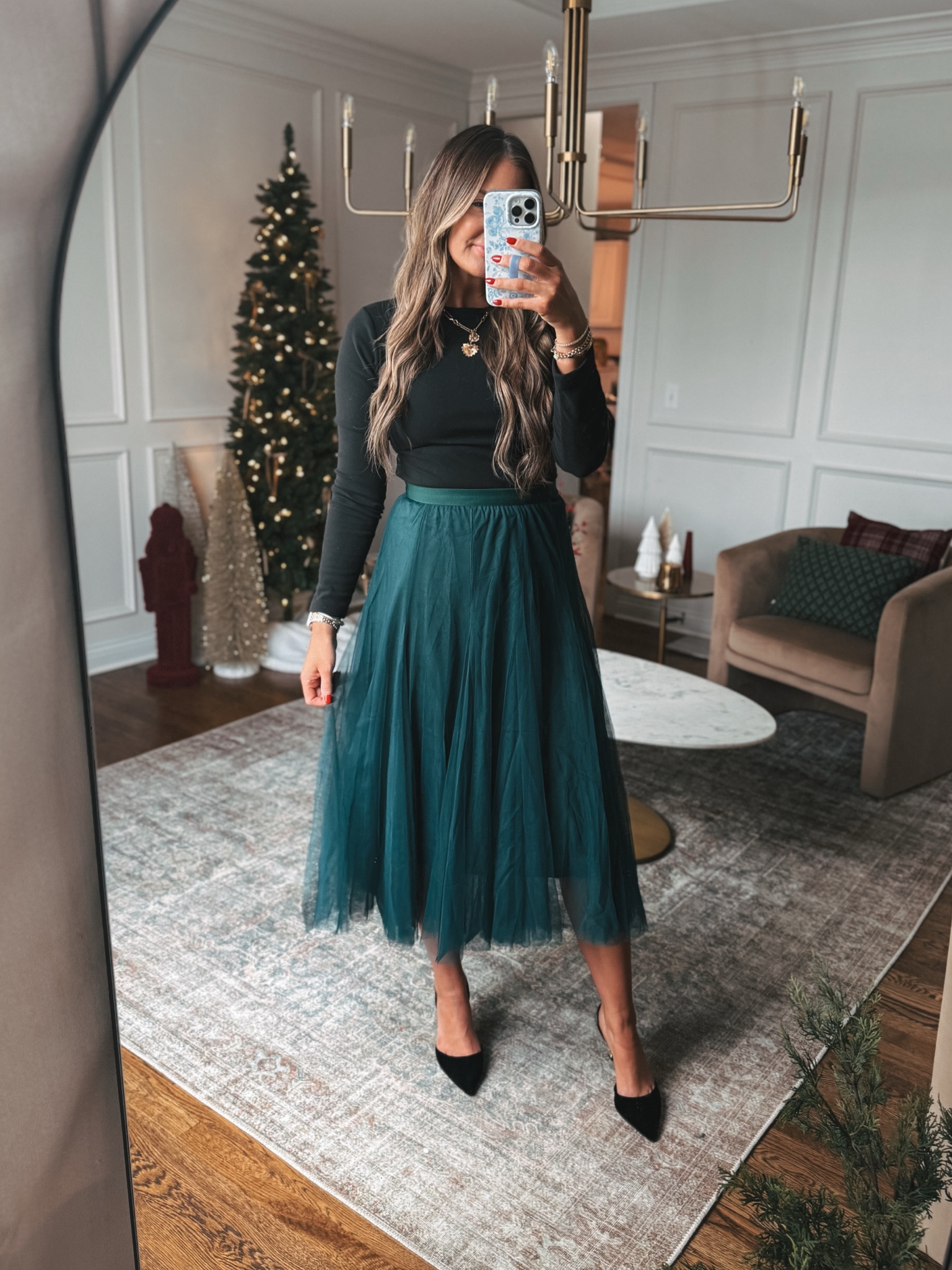 This green layered tulle skirt is perfect with a simple black top for a holiday party or winter event. I wore it with my black fleece lined bodysuit and it could be layered with a cropped jacket.

#LTKStyleTip #LTKFindsUnder50 #LTKHoliday