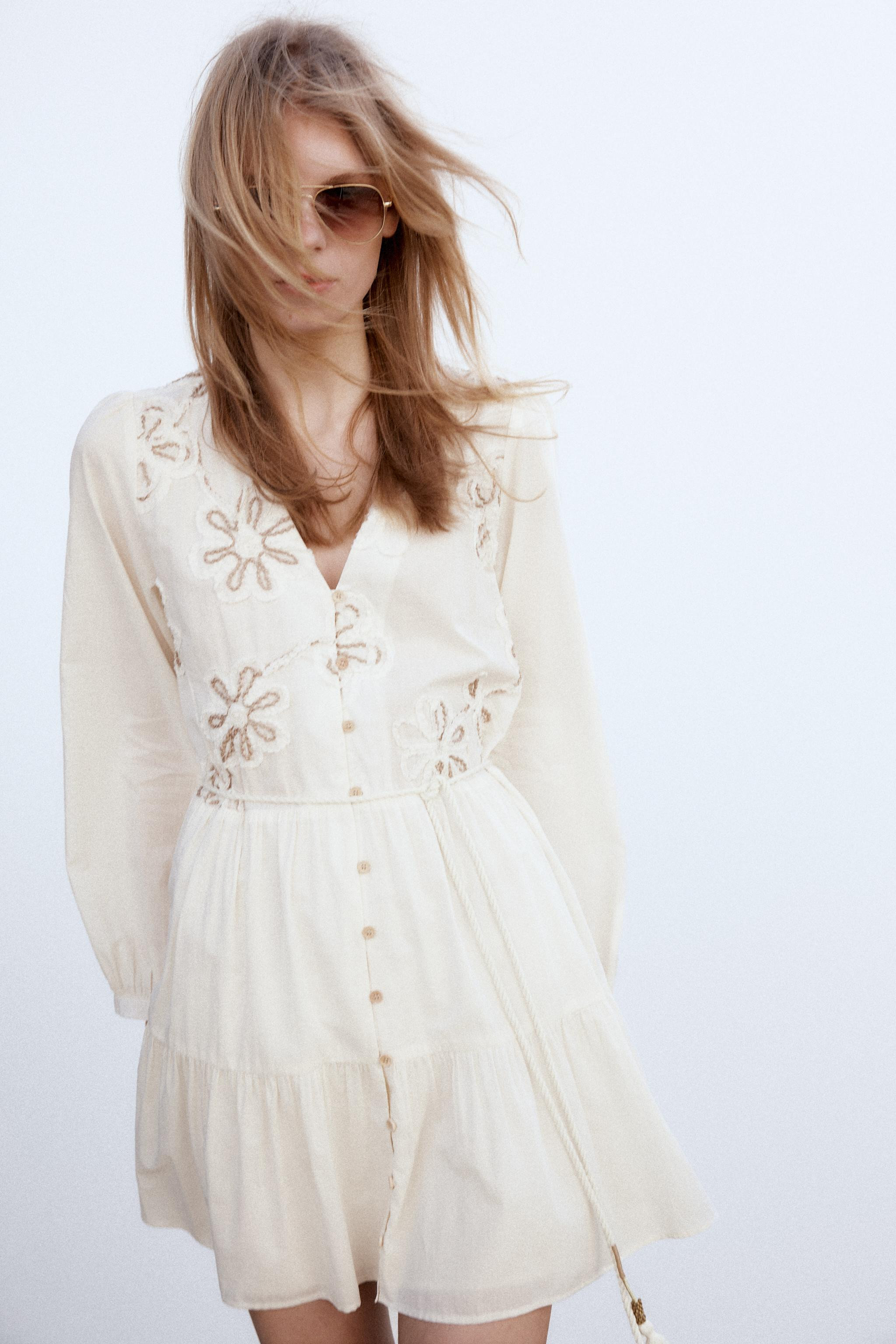 V-neck dress with long sleeves. Contrasting embroidered flowers and beaded cord belt with tassels... | Zara US