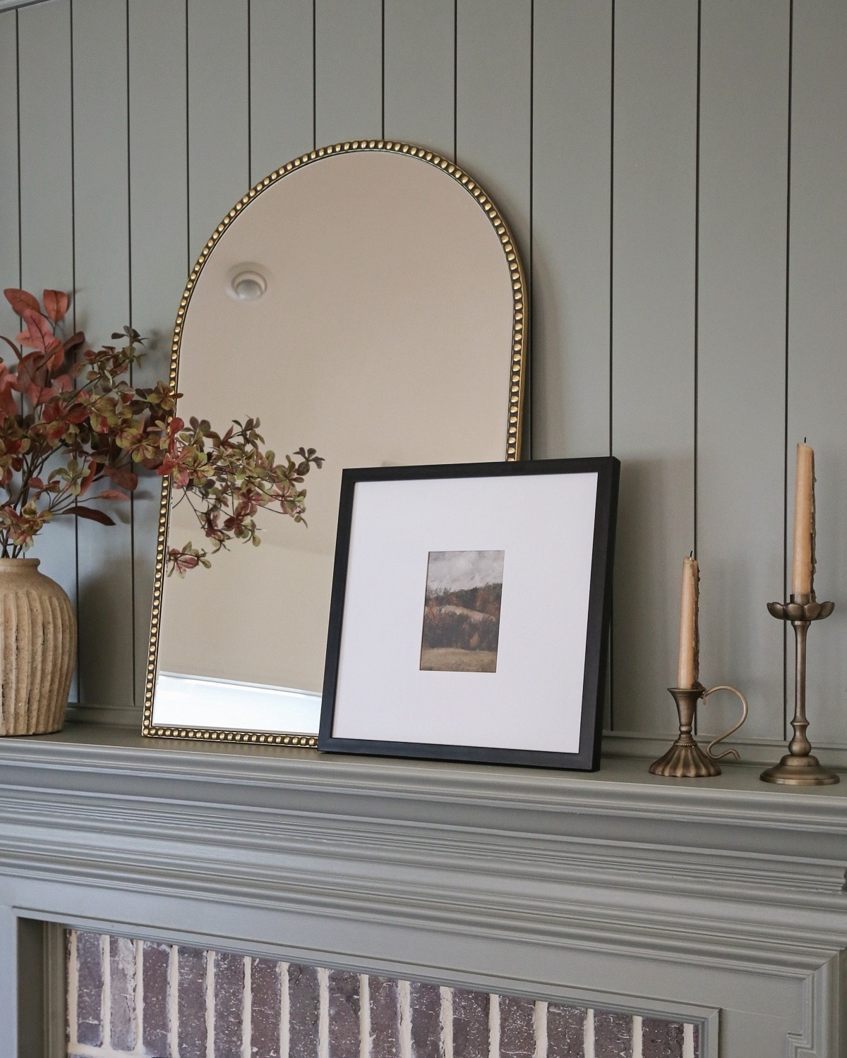 Brass candle holder, textured vase with fall stems, black picture frame, antiqued gold accent mirror

#LTKStyleTip #LTKHome #LTKSaleAlert