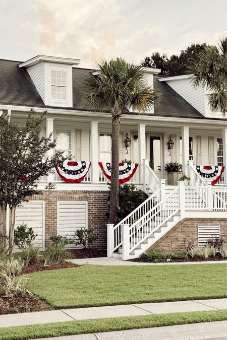 Making our coastal Charleston home ready for the holiday weekend 🇺🇸. I’ve wanted to add buntings to the porch for the longest time and found these for a great price! Grab them for the weekend & for the Fourth of July. Shop my porch, outfit, and decor by commenting FLAG and I’ll DM it all to you! 

#coastalhome #charlestonhome #cottagedecor #frontporch #southernliving #bhghome