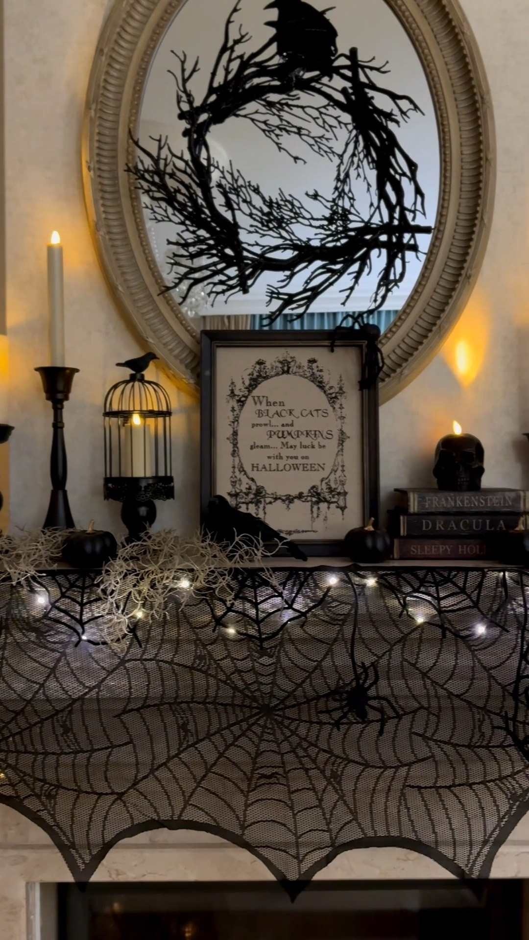 Halloween home decor, black skull candles, decorative crows, Halloween living room mantel