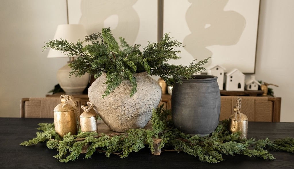Loving this earthy holiday moment 🎄🌿 A mix of natural greenery, textured pottery, and antique-style bells brings so much warmth to the dining room without feeling overly decorated. Beautiful inspo for holiday tablescapes, Christmas centerpiece ideas, organic winter decor, cozy Christmas styling, and minimal holiday home decor. 🌲🫶🏻

#LTKSeasonal #LTKHoliday #LTKHome