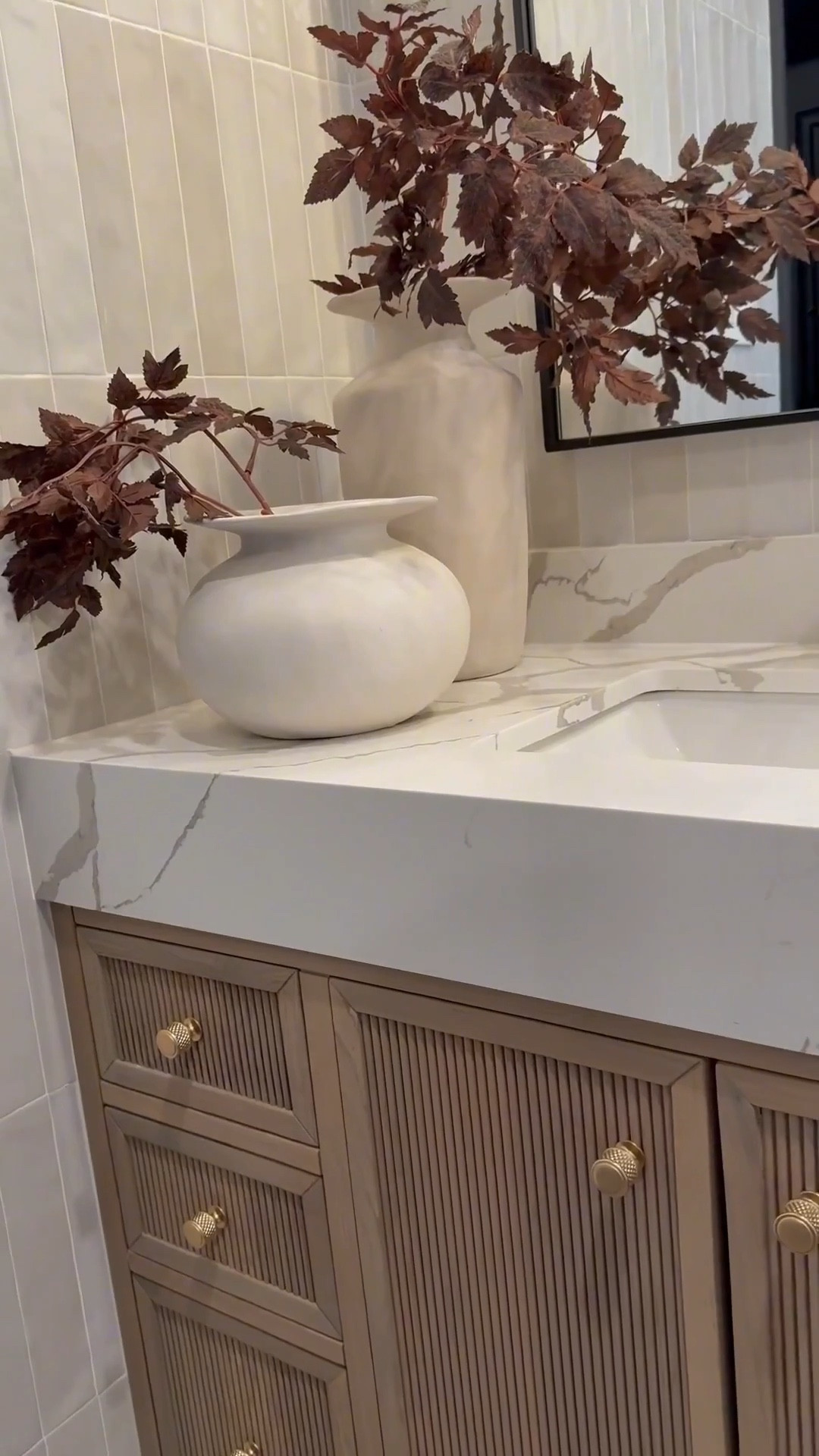 My bathroom vanity feels so warm and inviting with a few seasonal accents like these cimicifuga stems 🌿 The brown accent chair adds the perfect cozy tone 🪑 and I love how the backsplash and vanity combo keep everything neutral while still adding warmth 🤍

My artwork has been such a favorite 🎨 available in so many sizes and styles, it’s perfect 🤩 I’m also obsessed with my white oak console and dining tables that carry that same warmth throughout my home. And this vintage-inspired vase is so versatile, it works beautifully as a planter and adds that timeless look.🏺✨

#LTKHome #LTKSaleAlert