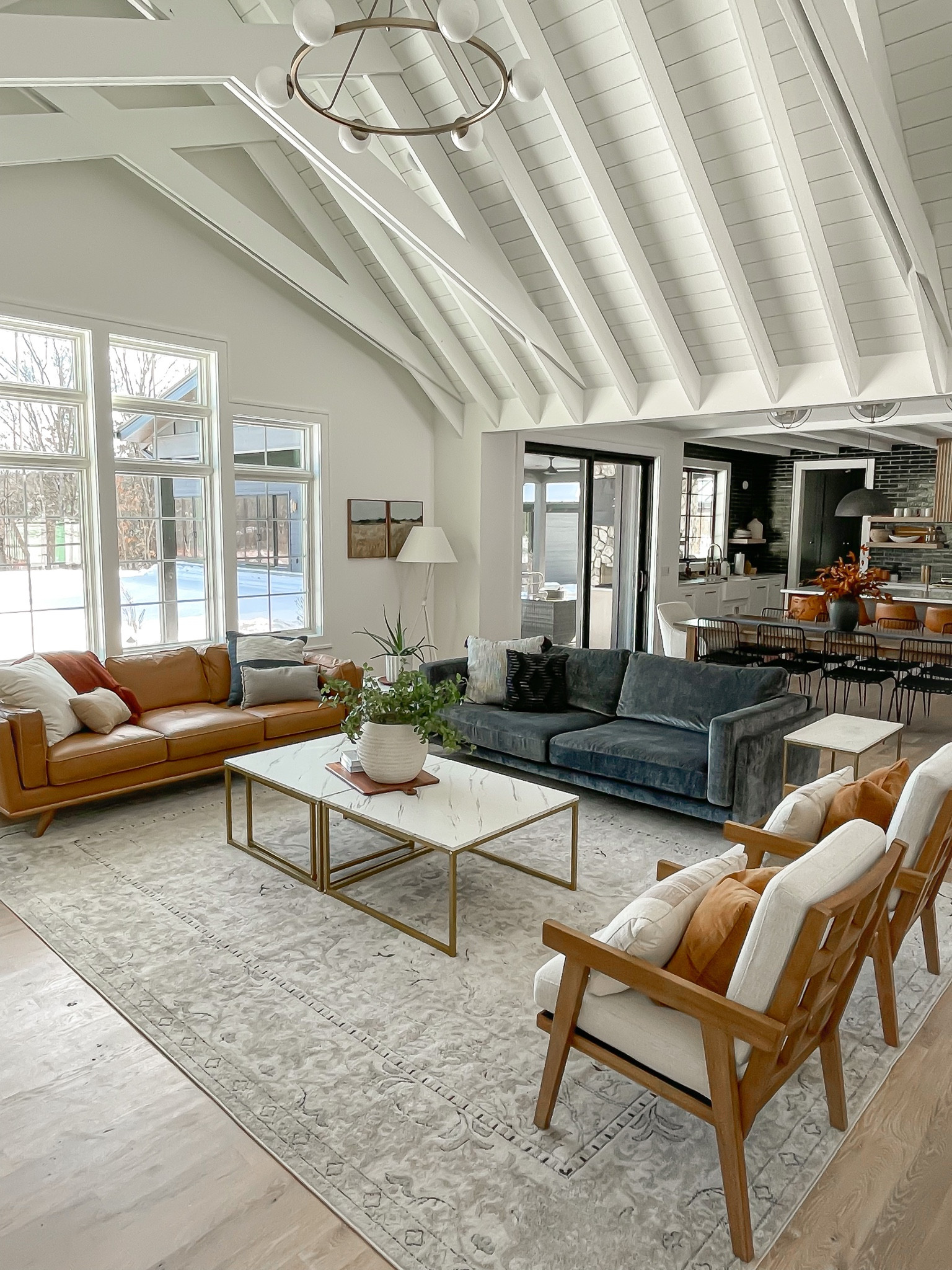 Great room, vaulted ceiling, leather sofa, velvet sofa, accent chairs, area rug, open floor plan, coffee table, end table

#LTKhome