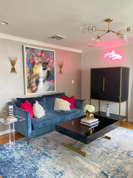 Sitting room with navy velvet sofa, black coffee table and pink neon sign  

#LTKOver40 #LTKStyleTip #LTKHome