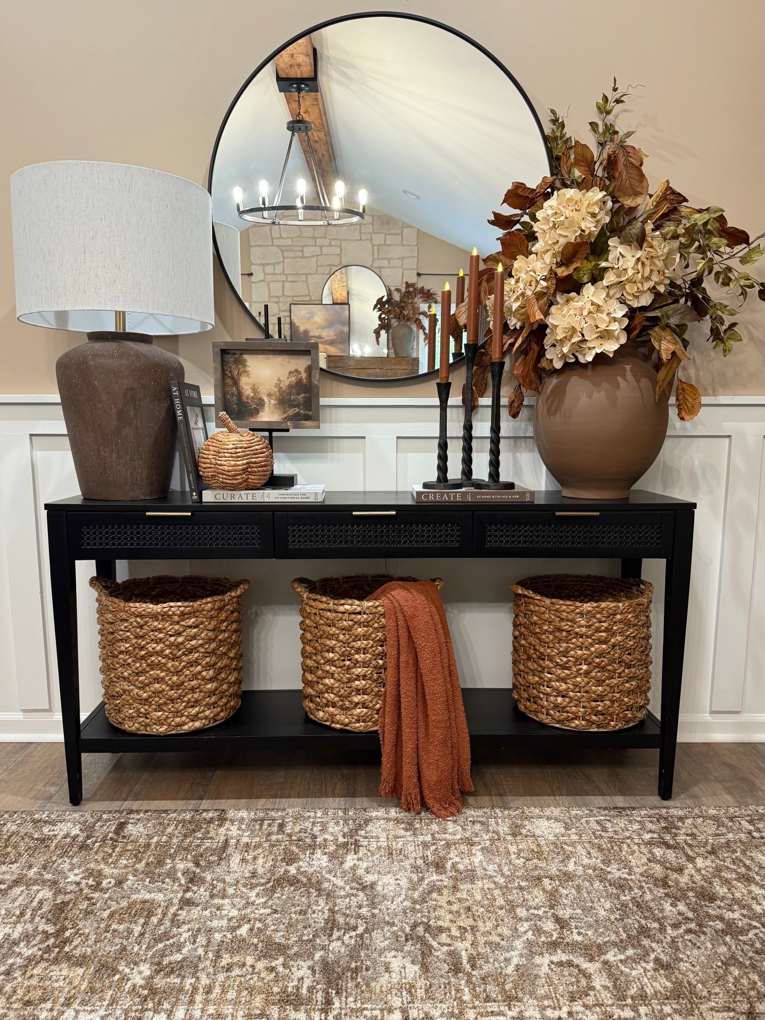 🍂✨Cozy & Classic Fall Console. 

Follow @farmtotablecreations on Instagram for more cozy home inspiration.

For reference:
•7x9 artwork in Briarsmoke stain. Use code FARMTOTABLE for 15% off. 
•Oversized Vase Florals:
3 Magnolia Stems
4 Cream Hydrangeas 
2 Grape Ivy Leaf Branches

This console is all dressed up for fall with layers of warmth and texture 🤎 From the oversized vase filled with rich autumn stems to the woven baskets, textured lamp, and cozy throw, every detail adds depth and coziness to the space. I love using stacked books and candleholders to bring height and balance, making it feel collected yet functional.

These pieces are timeless staples that you can easily mix and match for any season, and most are from my favorite retailers — simple swaps like stems and throws make it easy to transition your look from season to season.

#fallconsole #entrywaytable #fallstyling #fallhomedecor #falltabledecor #consoledecor #fallvibes #baskets #fallflorals #tablelamp #candlesticks #throwblanket #autumnvibes #homedecorideas

#LTKHome #LTKSaleAlert #LTKSeasonal