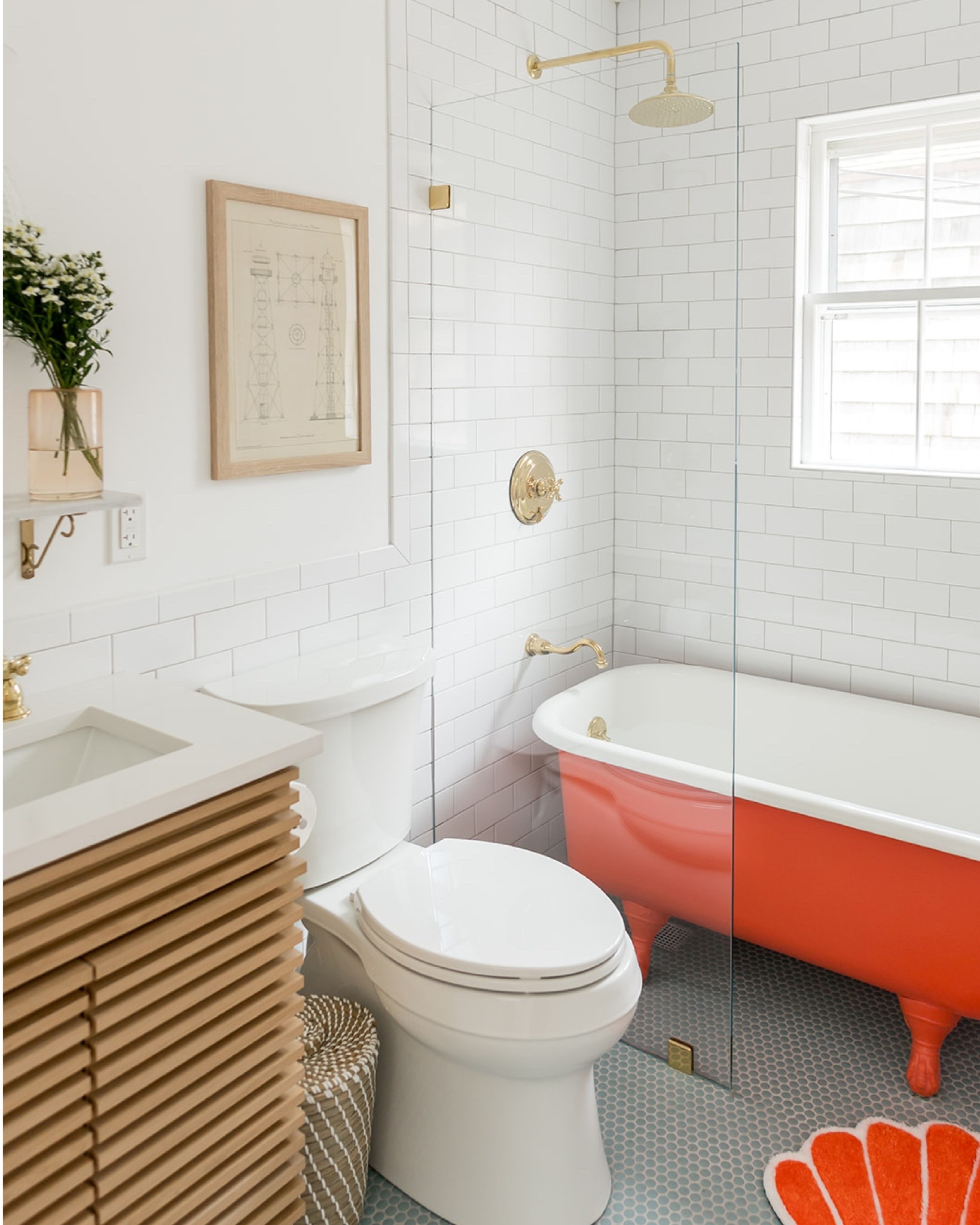 the existing bathroom at the #mixedusemini had a lot of character, but was in desperate need of some attention. we fell in love with the original, albeit diminutive clawfoot tub, so it became the focal point of our updated bathroom design. we painted the outside of the cast iron bathtub a vibrant coral and reglazed the inside for a fresh look. we also chose to rotate the tub so it ran across the width of the bathroom, maximizing the efficiency of the small space. because this is a vacation rental, we added plumbing for a modern shower, including a floor drain underneath the tub and a glass divider panel to keep the rest of the bathroom dry. simple white subway tile on the walls and blue penny tile on the floor add color and texture. #dwelloctoberstay #dwelloctober

#LTKHome #LTKFindsUnder50 #LTKFindsUnder100